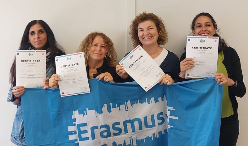 4 International teachers smiling and displaying certificates with Erasmus+ Flag